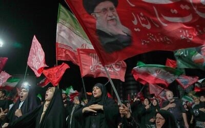 Demonstrators wave Iranian and religious flags, including one depicting the late Supreme Leader Ali Khamenei, during a pro-government gathering in Tehran, July 17, 2026. (AP/Vahid Salemi) Demonstrators wave Iranian and religious flags, including one depicting the late Supreme Leader Ali Khamenei, during a pro-government gathering in Tehran, July 17, 2026. (AP/Vahid Salemi)