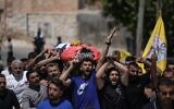 Mourners carry the body of Palestinian Fadi al-Naasan, 17, who succumbed to his wounds sustained during clashes with Israeli soldiers, during his funeral in the West Bank village of al-Mughayyir, July 18, 2026. (AP/Majdi Mohammed)