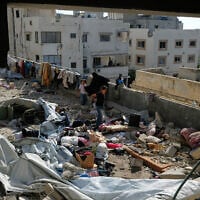 Residents inspect the site of an Israeli airstrike in Gaza city, July 18, 2026. (AP/Jehad Alshrafi)