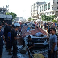 Residents inspect the site of an Israeli airstrike in Gaza city, July 18, 2026 (AP Photo/Jehad Alshrafi)