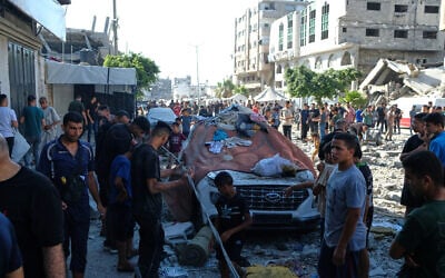 Residents inspect the site of an Israeli airstrike in Gaza city, July 18, 2026. (AP/Jehad Alshrafi)