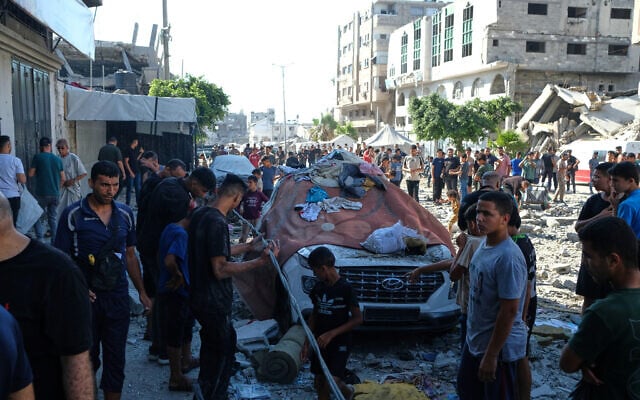 Residents inspect the site of an Israeli airstrike in Gaza city, July 18, 2026 (AP Photo/Jehad Alshrafi)