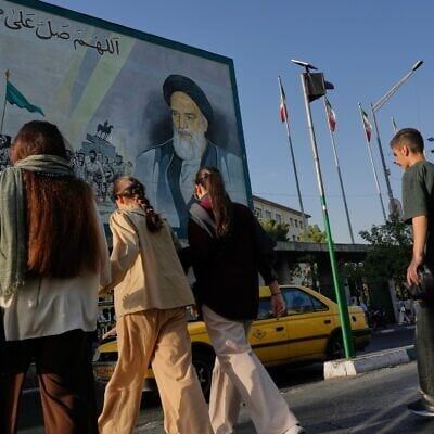 People cross the Islamic Revolution Street under a mural depicting a portrait of the late Iranian revolutionary founder Ayatollah Khomeini in downtown Tehran, Iran, July 18, 2026 (AP Photo/Vahid Salemi) People cross the Islamic Revolution Street under a mural depicting a portrait of the late Iranian revolutionary founder Ayatollah Khomeini in downtown Tehran, Iran, July 18, 2026 (AP Photo/Vahid Salemi)