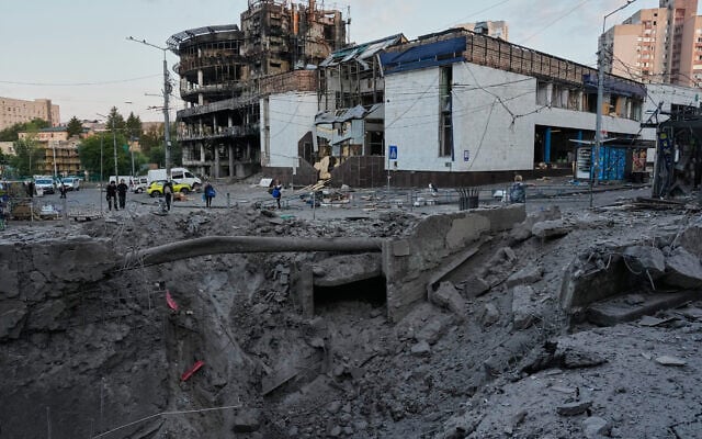 Debris surrounds a missile crater in the foreground of a building following a Russian missile attack in Kyiv, Ukraine, July 19, 2026. (AP/Efrem Lukatsky)