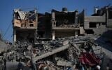 Palestinians inspects a destroyed building following an Israeli airstrike in Deir al-Balah, central Gaza Strip, July 19, 2026. (AP Photo/Abdel Kareem Hana)