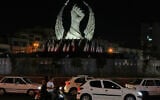 Vehicles drive past a monument depicting the clenched fist of the late Iranian supreme leader ayatollah Ali Khamenei, who was killed at the start of the US-Israel war with Iran, in Islamic Revolution Square in Tehran, July 19, 2026. (AP Photo/Vahid Salemi)