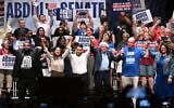 From left foreground, Michigan state Rep. Donavan McKinney, US Rep. Alexandria Ocasio-Cortez, Michigan Democratic US Senate primary candidate Abdul El-Sayed, US Sen. Bernie Sanders, United Auto Workers President Shawn Fain, and US Rep. Rashida Tlaib, join hands following a campaign rally for El-Sayed, July 18, 2026, in Detroit. (AP Photo/Jose Juarez)