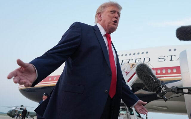 President Donald Trump speaks to reporters as he exits Air Force One at Joint Base Andrews, Maryland, after attending the World Cup final soccer match, July 19, 2026. (AP Photo/Jacquelyn Martin)