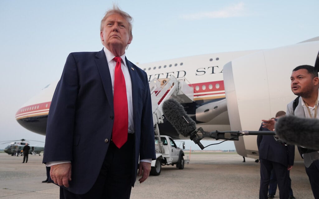 US President Donald Trump speaks to reporters as he exits Air Force One at Joint Base Andrews, Maryland, after attending the World Cup final soccer match, July 19, 2026. (AP Photo/ Jacquelyn Martin)