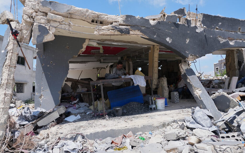 A resident works inside his shop, which was heavily damaged in an Israeli airstrike targeting Hezbollah, in Ghandouriyeh village, southern Lebanon, July 21, 2026. (AP Photo/Hassan Ammar)