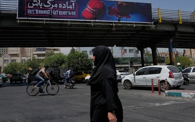 A woman walks past an anti-Trump billboard while crossing a street in downtown Tehran, July 21, 2026. (AP Photo/Vahid Salemi) A woman walks past an anti-Trump billboard while crossing a street in downtown Tehran, July 21, 2026. (AP Photo/Vahid Salemi)