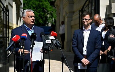 Former Hungarian prime minister and chairman of the Fidesz party Viktor Orban, left, and new faction leader of the party Janos Boka hold a press conference in front of the Fidesz headquarters in Lendvay Street in Budapest, Hungary, July 22, 2026. (Robert Hegedus/MTI via AP)