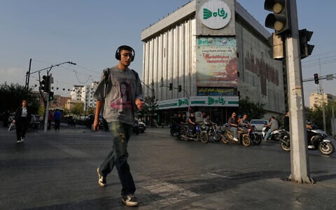 Pedestrians walk through downtown Tehran, July 22, 2026. (AP/Vahid Salemi)