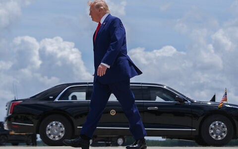 US President Donald Trump walks to the presidential limousine, known as The Beast, after arriving on Air Force One at Dobbins Air Reserve Base, July 22, 2026, in Marietta, Ga. (AP Photo/Julia Demaree Nikhinson)