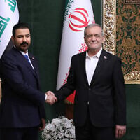 In this photo released by the Iranian Presidency Office, Iranian President Masoud Pezeshkian, right, shakes hands with Iraq’s Prime Minister Ali al-Zaidi during their meeting in Tehran, Iran, July 22, 2026. (Iranian Presidency Office via AP)