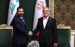 In this photo released by the Iranian Presidency Office, Iranian President Masoud Pezeshkian, right, shakes hands with Iraq’s Prime Minister Ali al-Zaidi during their meeting in Tehran, Iran, July 22, 2026. (Iranian Presidency Office via AP)