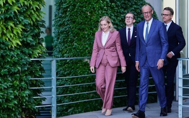 Chancellor Friedrich Merz, second from right, arrives with Nina Warken, left, Philipp Amthor, second from left, and Carsten Linnemann, right, for statement about planned personnel changes in his government at the chancellery in Berlin, Germany, July 24, 2026. (AP Photo/Markus Schreiber)