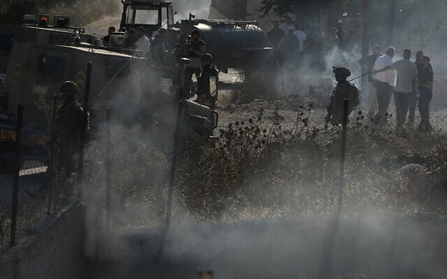 IDF troops are seen on a street following an attack by Israeli settlers in the village of Tell, near the West Bank city of Nablus, July 24, 2026. (AP Photo/Majdi Mohammed)