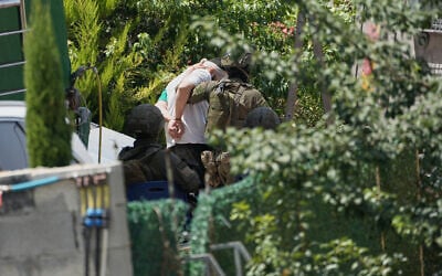 Israeli soldiers arrest a Palestinian man during an army operation in the West Bank village of Tell, near Nablus, July 25, 2026. (AP Photo/Majdi Mohammed)