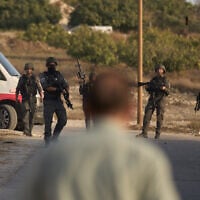 Members of Israeli security forces stand guard during a raid in the village of Sarra, near the West Bank city of Nablus, July 25, 2026. (AP Photo/Leo Correa)