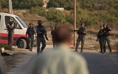Members of Israeli security forces stand guard during a raid in the village of Sarra, near the West Bank city of Nablus, July 25, 2026. (AP Photo/Leo Correa)