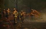 Firefighters battle a wildfire in San Martin de Valdeiglesias, west of Madrid, Spain, July 26, 2026. (AP Photo/Manu Fernandez)