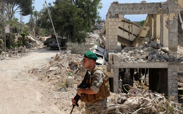 A Lebanese soldier stands in front of a destroyed house after deploying in the village of Zawtar al-Gharbiyeh, southern Lebanon, July 26, 2026. (AP Photo/Ahmad Mantash)