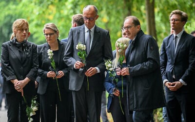 From left, Family Minister Karin Prien, Justice Minister Stefanie Hubig, German Chancellor Friedrich Merz, and German Interior Minister Alexander Dobrindt carry flowers as they visit Tiergarten park after an attacker rammed a vehicle into a crowd near Berlin’s annual Pride event, in Berlin, July 26, 2026. (Annegret Hilse/Pool Photo via AP) From left, Family Minister Karin Prien, Justice Minister Stefanie Hubig, German Chancellor Friedrich Merz, and German Interior Minister Alexander Dobrindt carry flowers as they visit Tiergarten park after an attacker rammed a vehicle into a crowd near Berlin’s annual Pride event, in Berlin, July 26, 2026. (Annegret Hilse/Pool Photo via AP)
