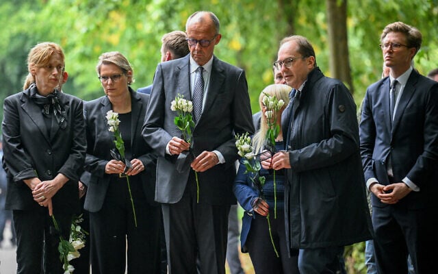 From left, Family Minister Karin Prien, Justice Minister Stefanie Hubig, German Chancellor Friedrich Merz, and German Interior Minister Alexander Dobrindt carry flowers as they visit Tiergarten park after an attacker rammed a vehicle into a crowd near Berlin’s annual Pride event, in Berlin, July 26, 2026. (Annegret Hilse/Pool Photo via AP) From left, Family Minister Karin Prien, Justice Minister Stefanie Hubig, German Chancellor Friedrich Merz, and German Interior Minister Alexander Dobrindt carry flowers as they visit Tiergarten park after an attacker rammed a vehicle into a crowd near Berlin’s annual Pride event, in Berlin, July 26, 2026. (Annegret Hilse/Pool Photo via AP)