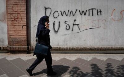 A woman talks on her cellphone as she walks past an anti-US graffiti on the wall of the British Embassy in Tehran, Iran, July 27, 2026. (AP Photo/Vahid Salemi) A woman talks on her cellphone as she walks past an anti-US graffiti on the wall of the British Embassy in Tehran, Iran, July 27, 2026. (AP Photo/Vahid Salemi)