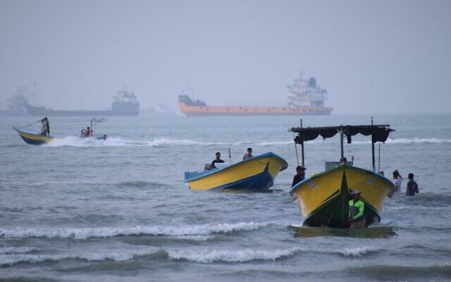 Small boats line the shore as cargo ships and other commercial vessels appear anchored in the Strait of Hormuz off Bandar Abbas, Iran, July 27, 2026. (Razieh Poudat/ISNA via AP)
