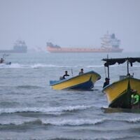 Small boats line the shore as cargo ships and other commercial vessels appear anchored in the Strait of Hormuz off Bandar Abbas, Iran, July 27, 2026. (Razieh Poudat/ISNA via AP)