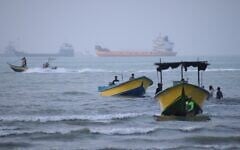 Small boats line the shore as cargo ships and other commercial vessels appear anchored in the Strait of Hormuz off Bandar Abbas, Iran, July 27, 2026. (Razieh Poudat/ISNA via AP)