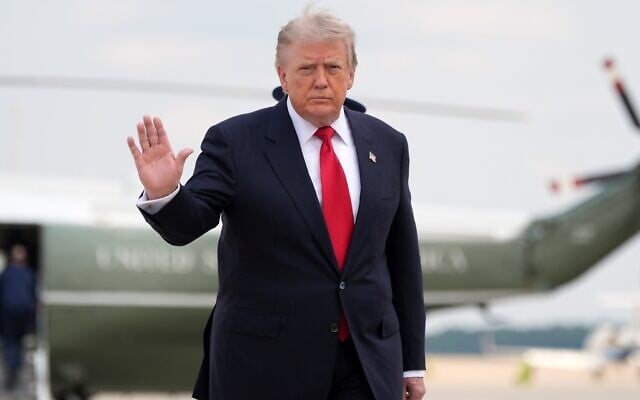 US President Donald Trump waves as he walks from Marine One to board Air Force One, July 27, 2026, at Joint Base Andrews, Maryland. (AP Photo/Alex Brandon)