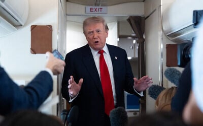 US President Donald Trump speaks with reporters while on Air Force One en route to Oakland County International Airport, July 27, 2026, in Waterford Township, Mich. (AP Photo/ Alex Brandon)