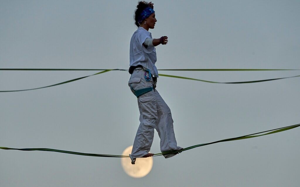 An acrobat rehearses on high wires stretched above Hinnom Valley in Jerusalem, preparing an aerial performance for the Israel Festival’s opening event, echoing Philippe Petit’s 1987 crossing of the same valley, July 27, 2026. (AP Photo/Ohad Zwigenberg)