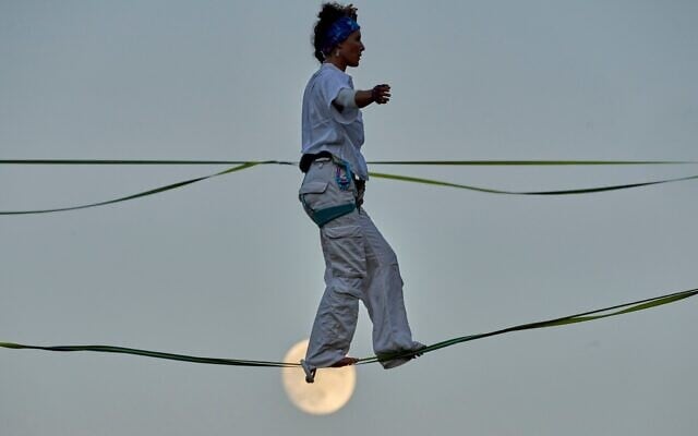 An acrobat rehearses on high wires stretched above Hinnom Valley in Jerusalem, preparing an aerial performance for the Israel Festival’s opening event, echoing Philippe Petit’s 1987 crossing of the same valley, July 27, 2026. (AP Photo/Ohad Zwigenberg)