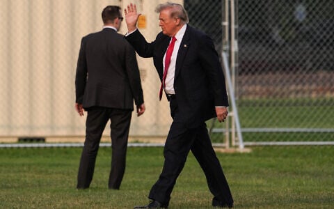 President Donald Trump waves while walking on the Ellipse after arriving on Marine One, July 27, 2026, near the White House in Washington. (AP/Julia Demaree Nikhinson)