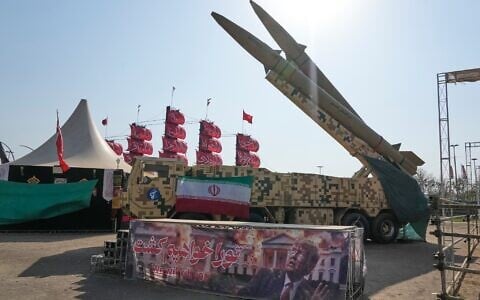 Iranian missiles are displayed by the armed forces as an anti-Trump banner declaring in English and Farsi, 'We will kill you,' is seen in a temporary exhibition at Azadi (Freedom) Square in Tehran, Iran, July 29, 2026. (AP Photo/Vahid Salemi)