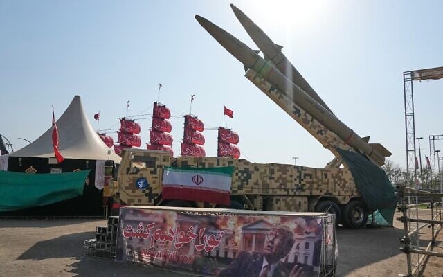 Iranian missiles are displayed by the armed forces as an anti-Trump banner declaring in English and Farsi, 'We will kill you,' is seen in a temporary exhibition at Azadi (Freedom) Square in Tehran, Iran, July 29, 2026. (AP Photo/Vahid Salemi)