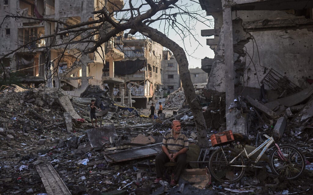 Palestinians inspect the rubble of a building and tents destroyed in an Israeli airstrike in Gaza City, July 30, 2026. (AP Photo/Jehad Alshrafi)