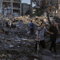 Palestinians inspect the rubble of a building and tents destroyed in an Israeli airstrike in Gaza City, July 30, 2026. (AP Photo/Jehad Alshrafi)