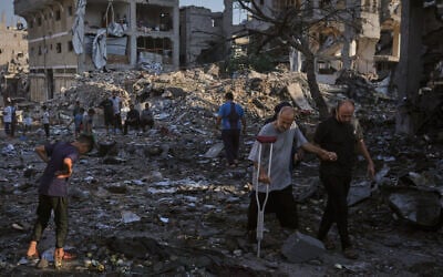 Palestinians inspect the rubble of a building and tents destroyed in an Israeli airstrike in Gaza City, July 30, 2026. (AP Photo/Jehad Alshrafi)