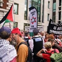 Demonstrators gather outside the Westminster Magistrates Court in London, July 30, 2026, as a plea hearing for 25 people accused of showing support for Palestine Action takes place. (AP/Alberto Pezzali)