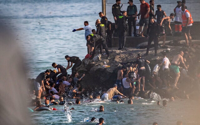 Migrants try to cross from Morocco into the Spanish enclave of Ceuta, July 30, 2026. (AP/Antonio Sempere)