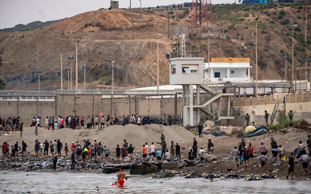 Migrants return to Morocco from the Spanish enclave of Ceuta, July 31, 2026. (AP Photo/Antonio Sempere)