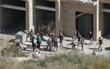 Israeli settlers carry cardboard boxes from a building under construction in the Palestinian village of Tell, in the West Bank, July 31, 2026. (AP Photo/Majdi Mohammed)