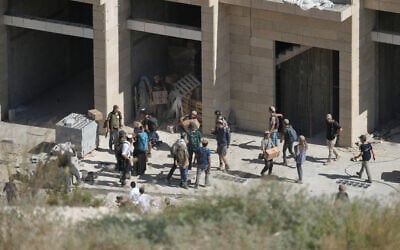 Israeli settlers carry cardboard boxes from a building under construction in the Palestinian village of Tell, in the West Bank, July 31, 2026. (AP Photo/Majdi Mohammed) Israeli settlers carry cardboard boxes from a building under construction in the Palestinian village of Tell, in the West Bank, July 31, 2026. (AP Photo/Majdi Mohammed)