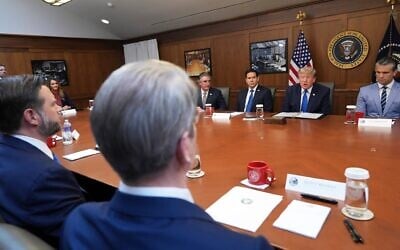 US President Donald Trump speaks, joined by Defense Secretary Pete Hegseth, right, Secretary of State Marco Rubio, from third left, Interior Secretary Doug Burgum, and from bottom row left, Vice President JD Vance and Treasury Secretary Scott Bessent, speaks during a cabinet meeting, July 31, 2026, at Camp David, the presidential retreat, near Thurmont, Maryland, July 31, 2026. (AP Photo/Jacquelyn Martin)