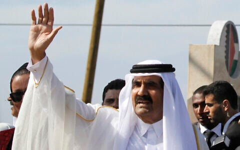 Emir of Qatar Sheikh Hamad bin Khalifa al-Thani waves to the crowd as he arrives with senior Hamas officials for a cornerstone-laying ceremony of a Qatari funded rehabilitation center in Gaza City,  October 23, 2012. (Hatem Moussa/ Pool photo via AP)